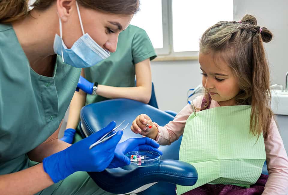 Dentist Giving Child Colorful Braces Elastic Bands