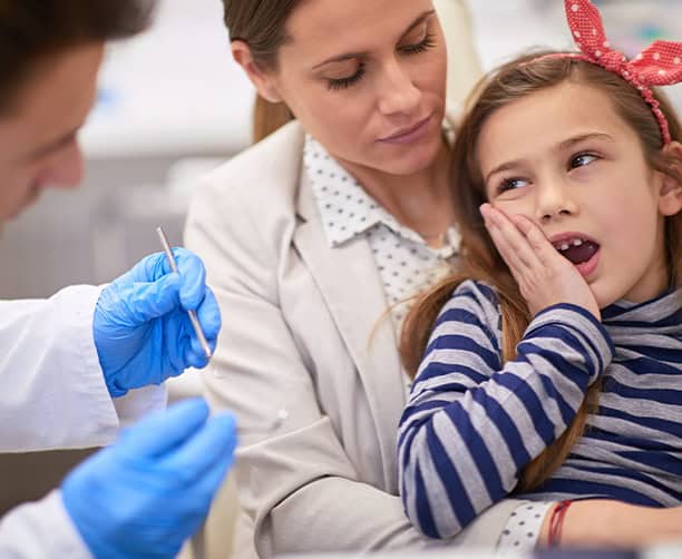 Girl With Tooth Pain Visiting Pediatric Dentist