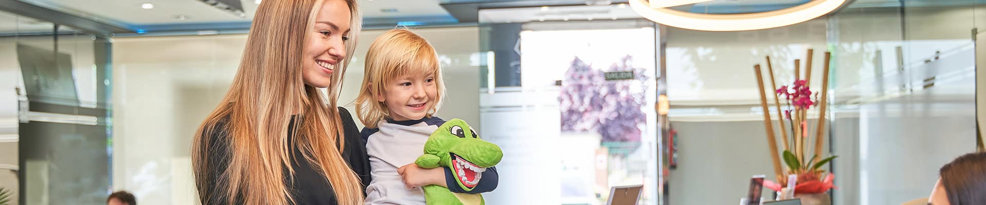 Mother And Child Arriving At Pediatric Dental Clinic