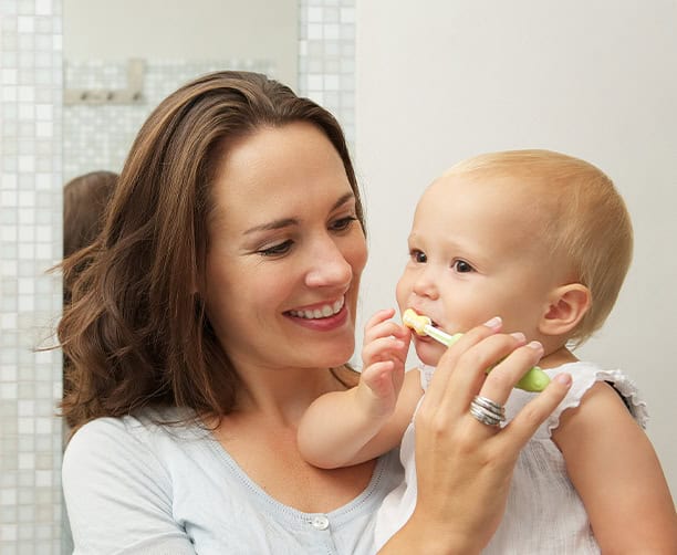 Mother Teaching Baby How Brush Teeth With Toothbrush
