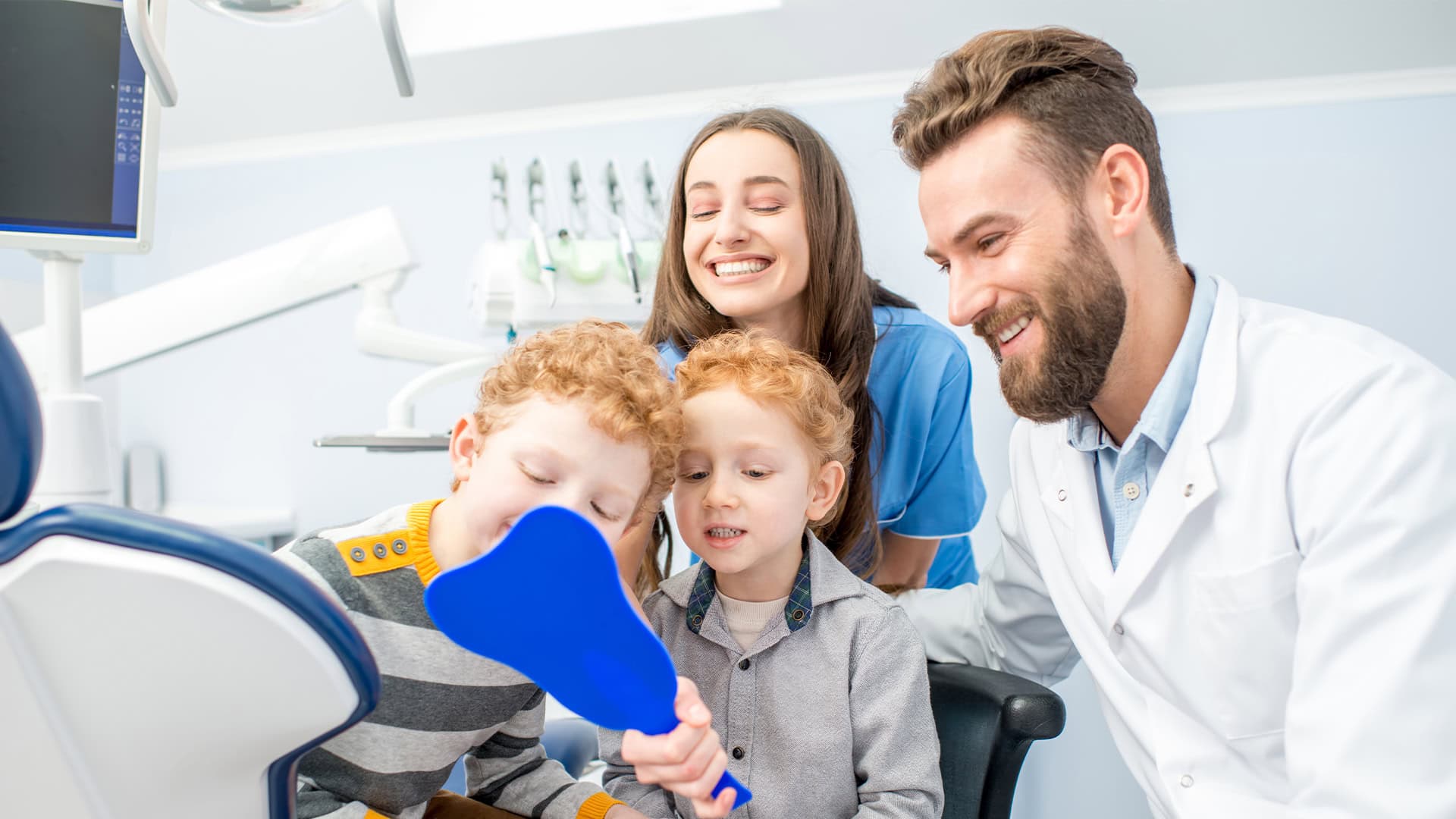 Pediatric Dentist Checking Child Teeth With Mirror