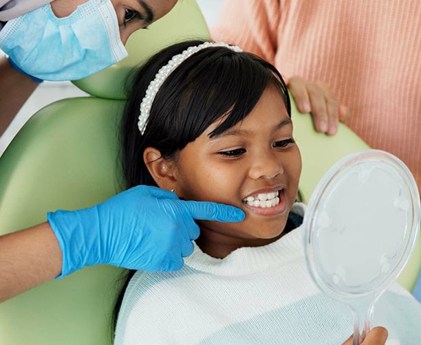 Pediatric Dentist Showing Child Healthy Smile With Mirror