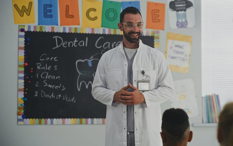 Pediatric Dentist Teaching Children Dental Care Classroom