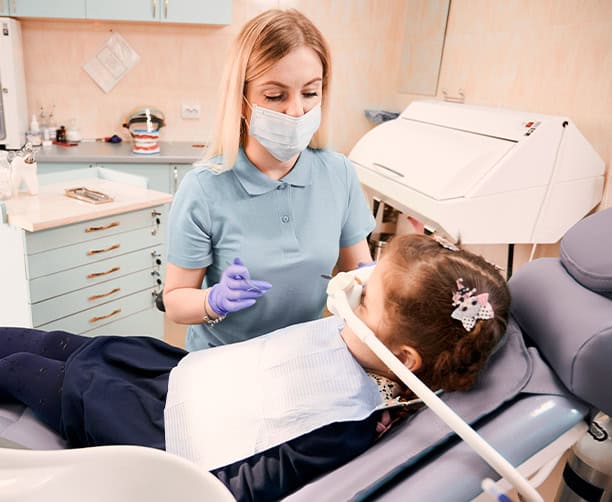 Pediatric Dentist Treating Child With Nitrous Oxide Sedation